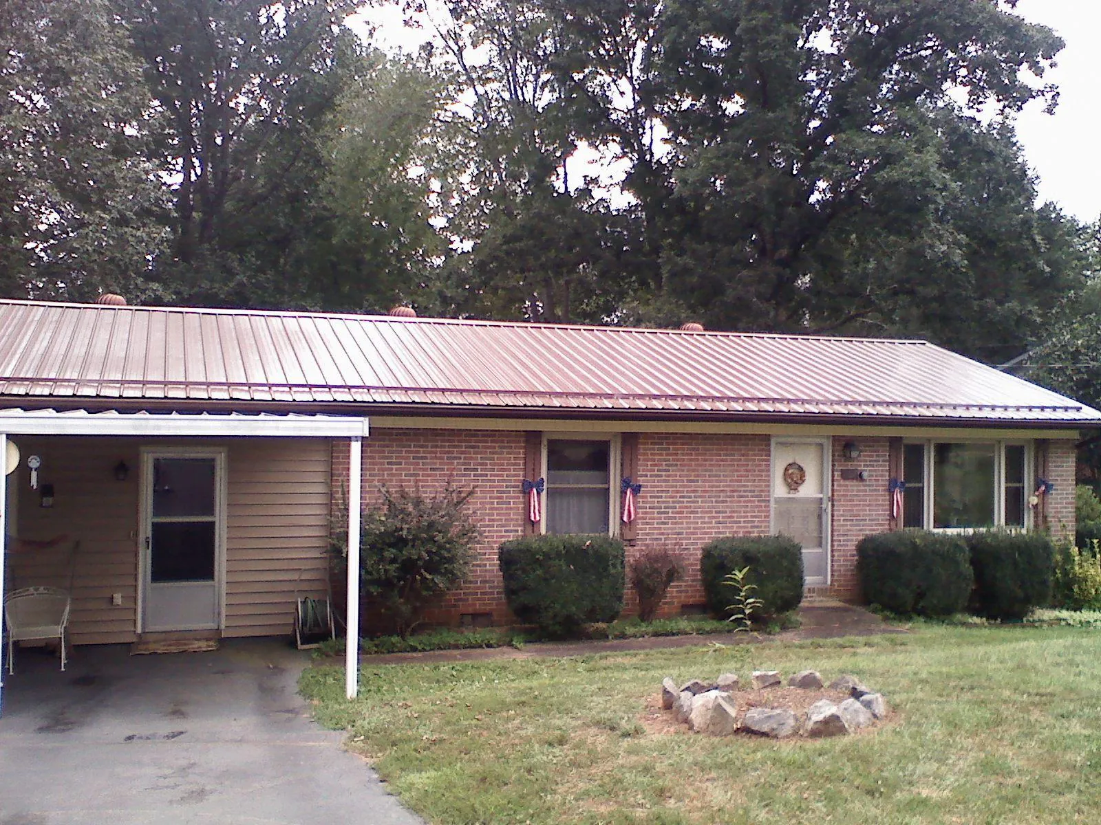 Bronze metal roof and carport on a brick ranch home — Roof Repair work by our crew in Franklin Park