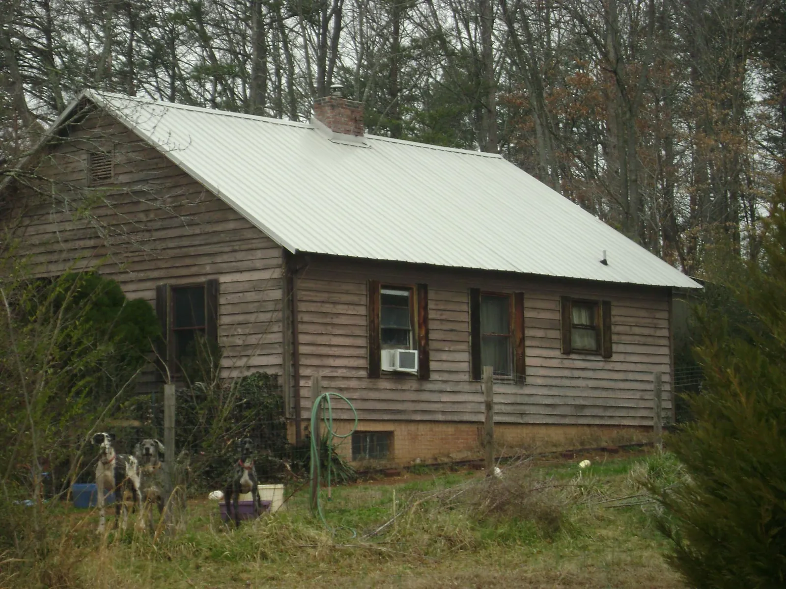 White metal roof on an old wood sided farmhouse, from a Metal Roof Installation job in Franklin Park